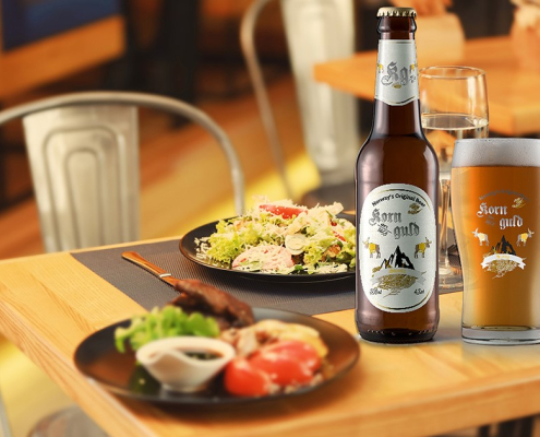 Plates with tasty dishes on wooden table in restaurant